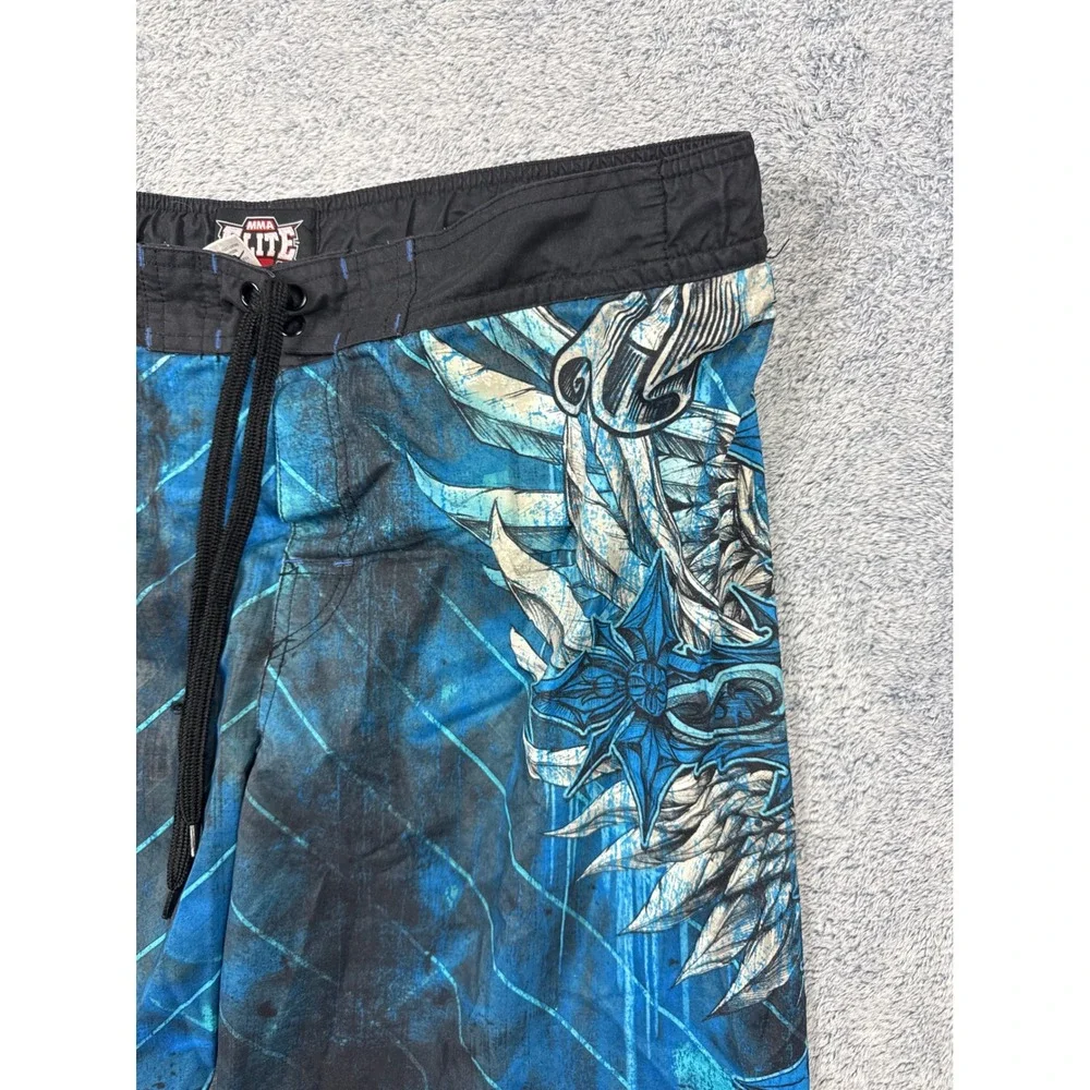 MMA Elite Mens Size M Blue Board Shorts Graphic Cross Wing Swim Trunks